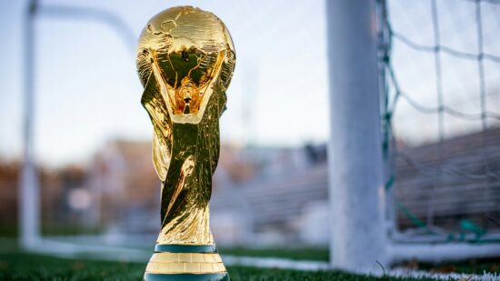 international football trophy sitting on soccer field near the goals